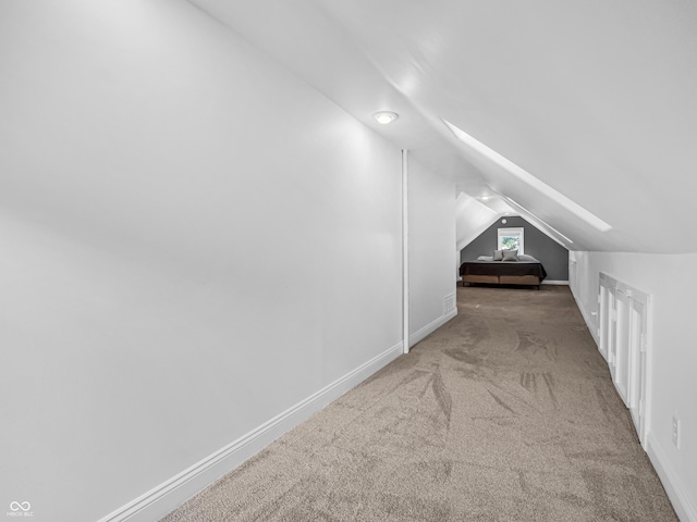 additional living space featuring lofted ceiling, carpet, and baseboards