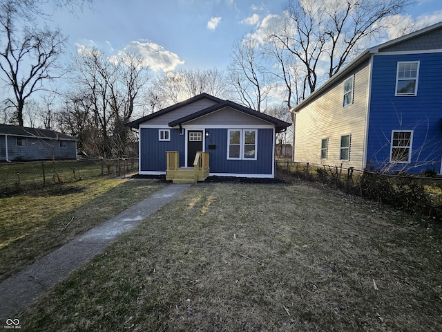 view of front of home with a front yard and a fenced backyard