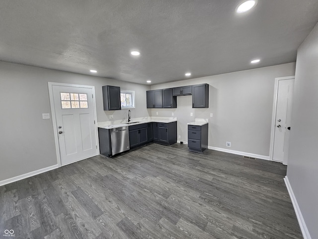 kitchen featuring dishwasher, dark wood finished floors, baseboards, and a sink