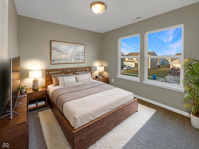 bedroom featuring visible vents and baseboards