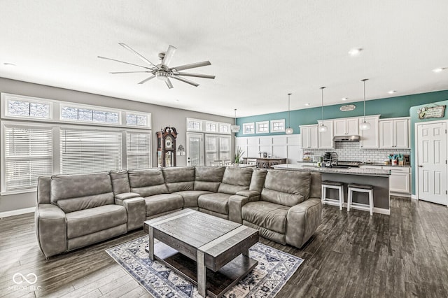 living room featuring dark wood finished floors, recessed lighting, baseboards, and a ceiling fan