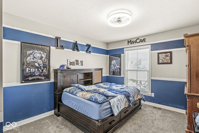 carpeted bedroom featuring visible vents, baseboards, and a textured ceiling