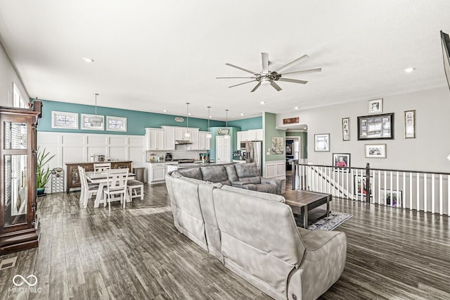 living area featuring recessed lighting, visible vents, dark wood finished floors, and a ceiling fan