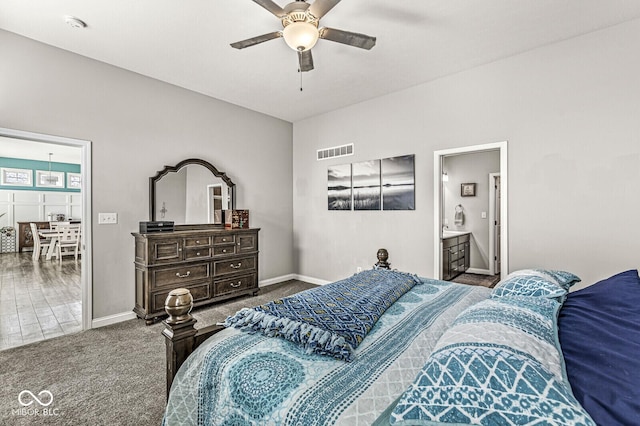 carpeted bedroom with visible vents, a ceiling fan, and baseboards