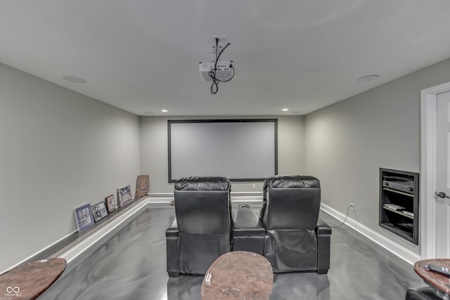 cinema featuring finished concrete floors, recessed lighting, and baseboards