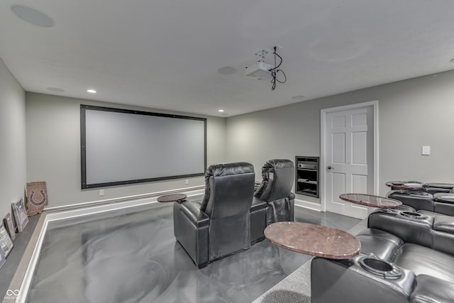 cinema room with recessed lighting and finished concrete flooring