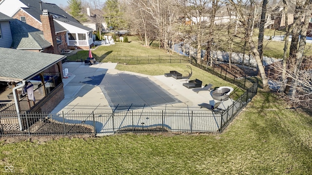 view of swimming pool with a residential view, a patio, a yard, and fence