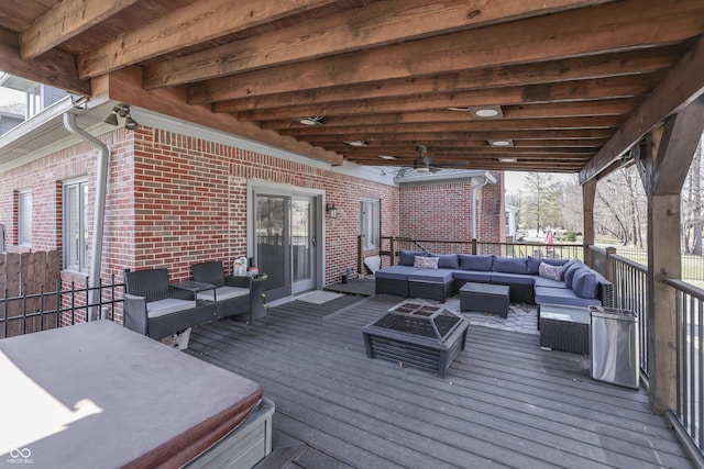 wooden deck with a ceiling fan and an outdoor hangout area