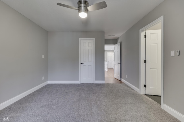 unfurnished bedroom featuring baseboards, carpet floors, and ceiling fan