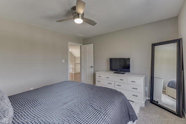 bedroom featuring ceiling fan and light carpet