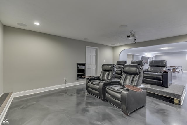 cinema room with recessed lighting, finished concrete flooring, and baseboards