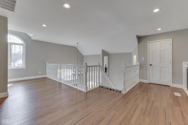 empty room with visible vents, recessed lighting, baseboards, and wood finished floors