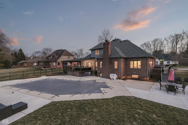 view of pool with a deck, a patio, fence, a yard, and a fenced in pool