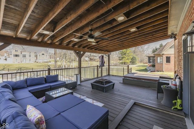 deck featuring an outdoor living space with a fire pit and ceiling fan