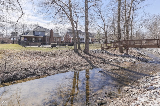 view of yard with fence and a water view