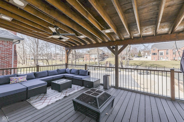 wooden deck with a ceiling fan, a residential view, and an outdoor hangout area