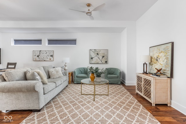 living room featuring baseboards, wood finished floors, and a ceiling fan