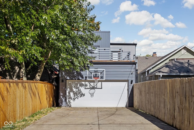 exterior space with a garage and fence