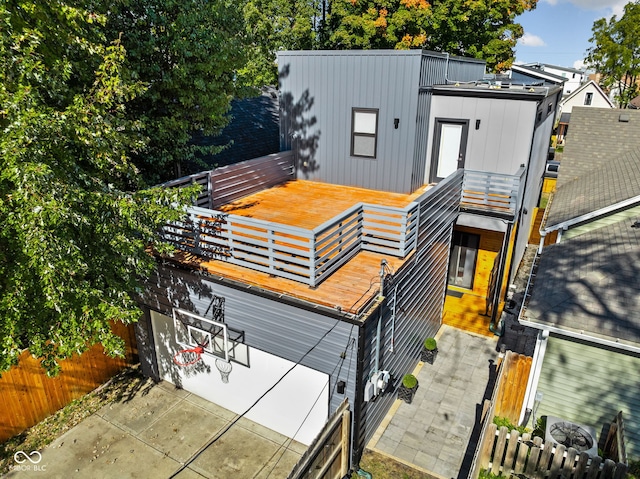 view of front of house with a balcony, fence, and board and batten siding