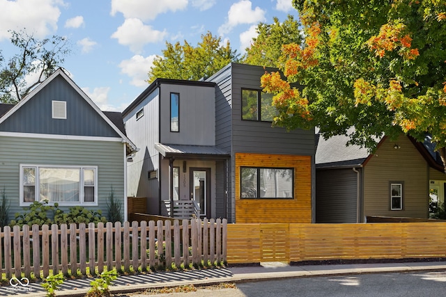 view of front facade with a fenced front yard and metal roof