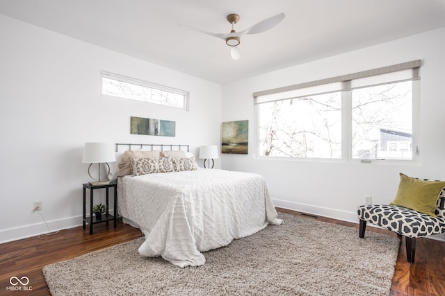 bedroom with visible vents, multiple windows, baseboards, and wood finished floors