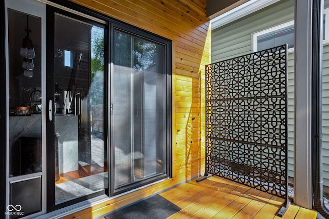 bathroom with wood-type flooring and wooden walls