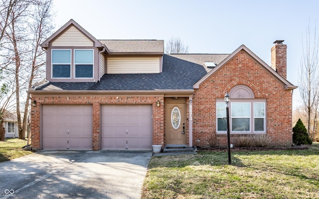 view of front of house featuring a front lawn, roof with shingles, concrete driveway, brick siding, and a chimney