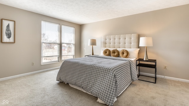 carpeted bedroom featuring baseboards and a textured ceiling