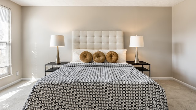 carpeted bedroom with baseboards and multiple windows