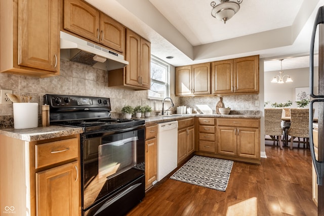 kitchen featuring dark wood-type flooring, black range with electric stovetop, under cabinet range hood, backsplash, and white dishwasher