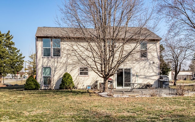 rear view of property featuring a patio area and a yard