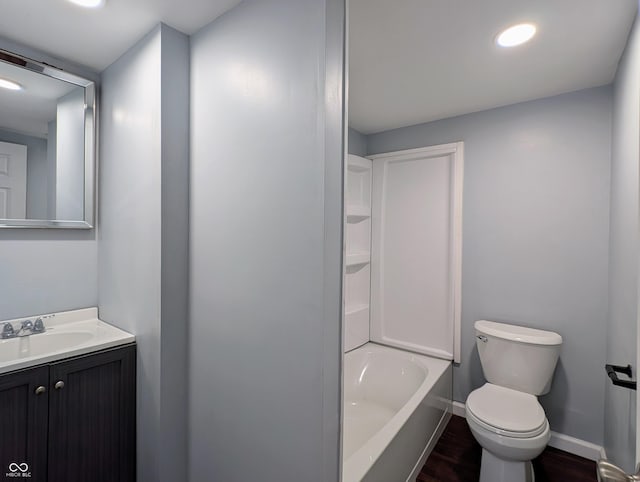 full bath with baseboards, toilet, recessed lighting, wood finished floors, and vanity