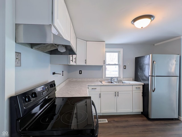 kitchen with range hood, freestanding refrigerator, black electric range, white cabinetry, and a sink