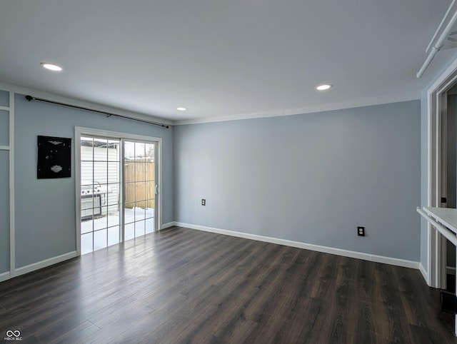 empty room with dark wood finished floors, recessed lighting, and baseboards