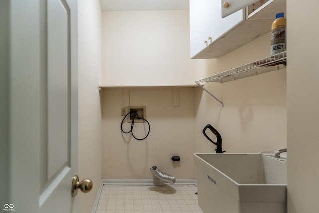 washroom featuring a sink, cabinet space, and washer hookup