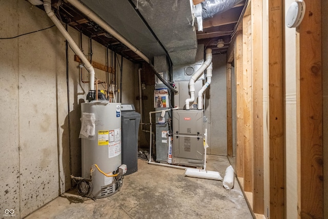 utility room with heating unit and water heater