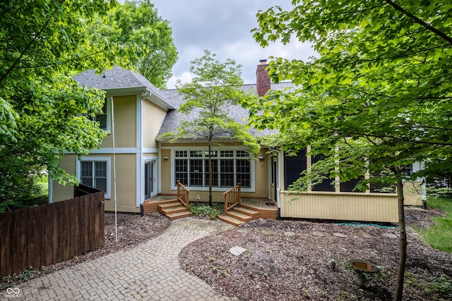 12348 Seaway Cir, Indianapolis, IN 46236 - rear view of property featuring roof with shingles, a chimney, and fence