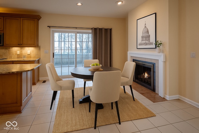 12348 Seaway Cir, Indianapolis, IN 46236 - dining space with a tile fireplace, light tile patterned flooring, and recessed lighting