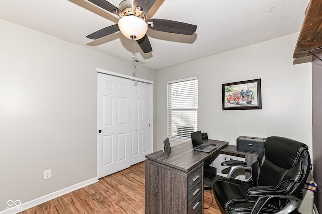 home office featuring a ceiling fan, visible vents, baseboards, and light wood-type flooring