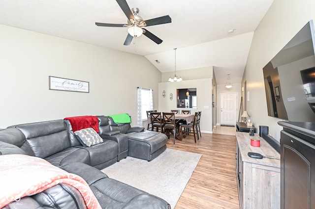 living area with vaulted ceiling, light wood-style flooring, ceiling fan with notable chandelier, and baseboards