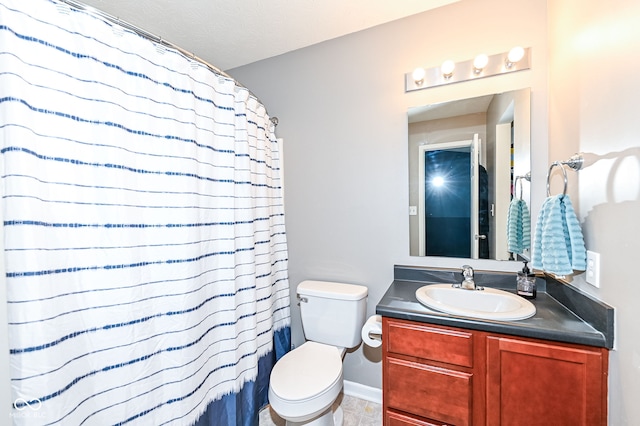 bathroom with vanity, a shower with shower curtain, and toilet