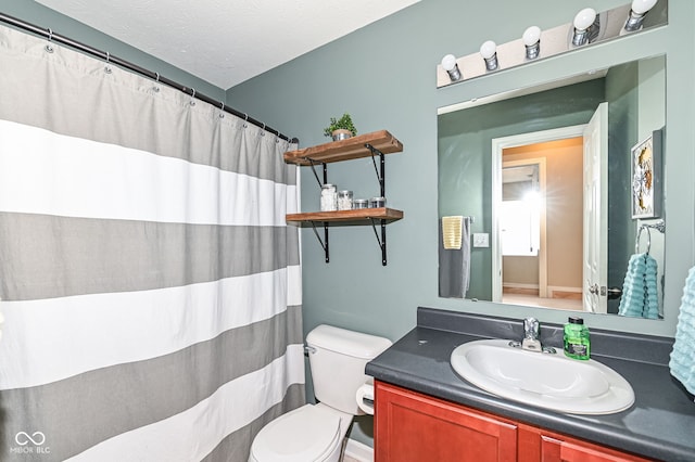 full bath with curtained shower, a textured ceiling, toilet, and vanity