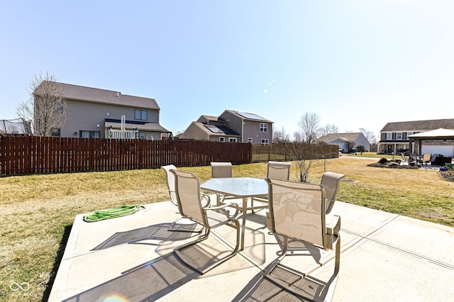 view of patio / terrace with a residential view, outdoor dining area, and fence