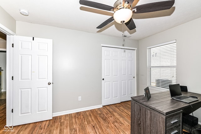 office with a ceiling fan, visible vents, wood finished floors, and baseboards