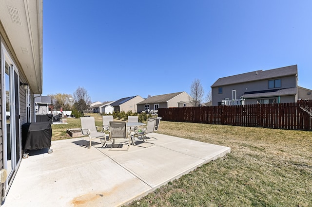 view of patio with fence, a residential view, and grilling area