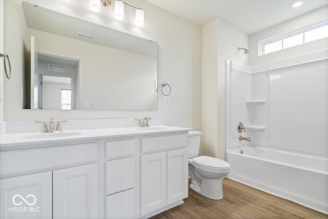 bathroom with visible vents, toilet, and a sink