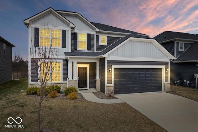 view of front of property featuring board and batten siding, an attached garage, and driveway