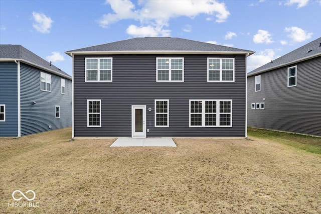 back of property featuring a yard and a patio