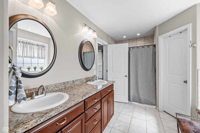 full bathroom with curtained shower, double vanity, recessed lighting, and a sink