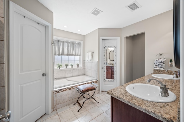 bathroom featuring a sink, visible vents, and a bath